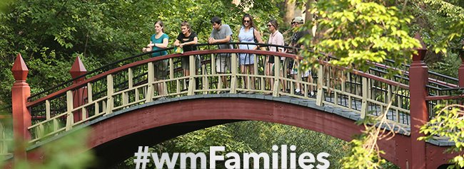 Five people standing on the Crim Dell bridge on campus with #wmFamilies