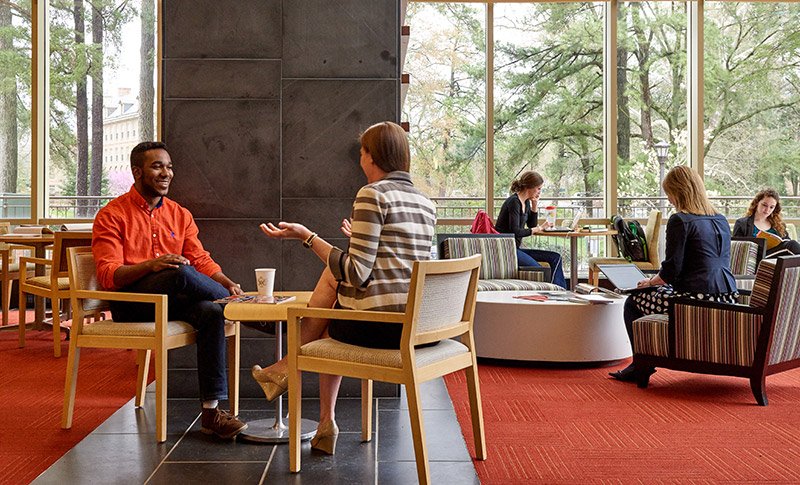 Small groups of students in conversation with one another in the Career Center lobby